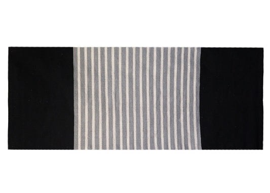 Hand-woven black and grey Indian cotton rug with a neutral pattern, sized perfectly for a hallway or yoga mat.