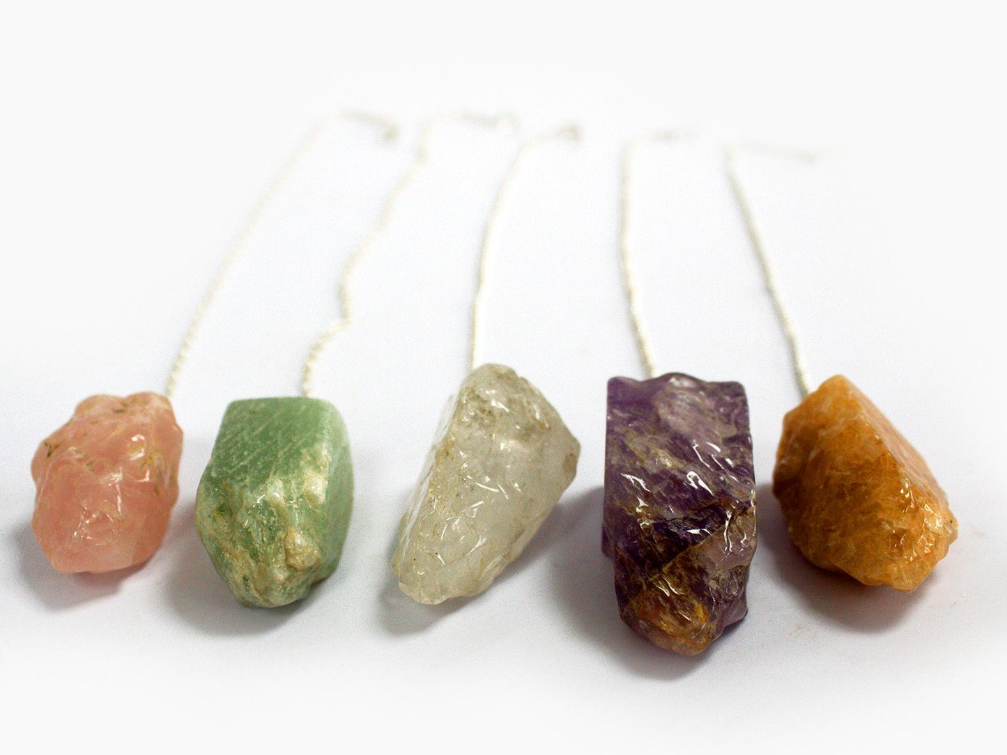 Assorted natural gemstone pendulums in various colours with silver-tone chains and matching bead ends.
