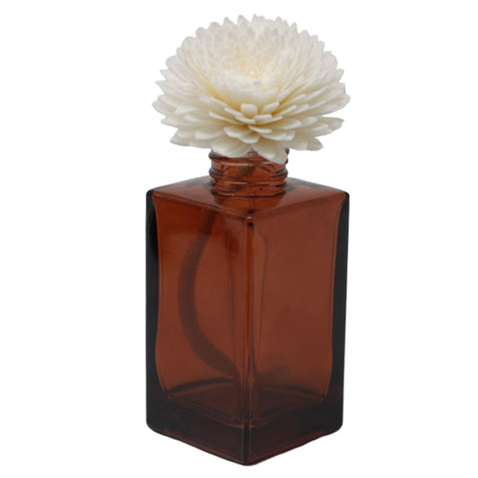 A large, handcrafted white carnation flower made from sola wood with an attached cotton string for aroma diffusion.