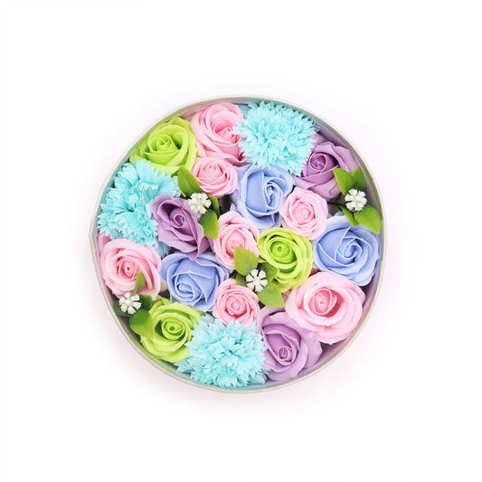 Round gift box filled with delicate blue soap flower roses and greenery, perfect for a baby shower gift.