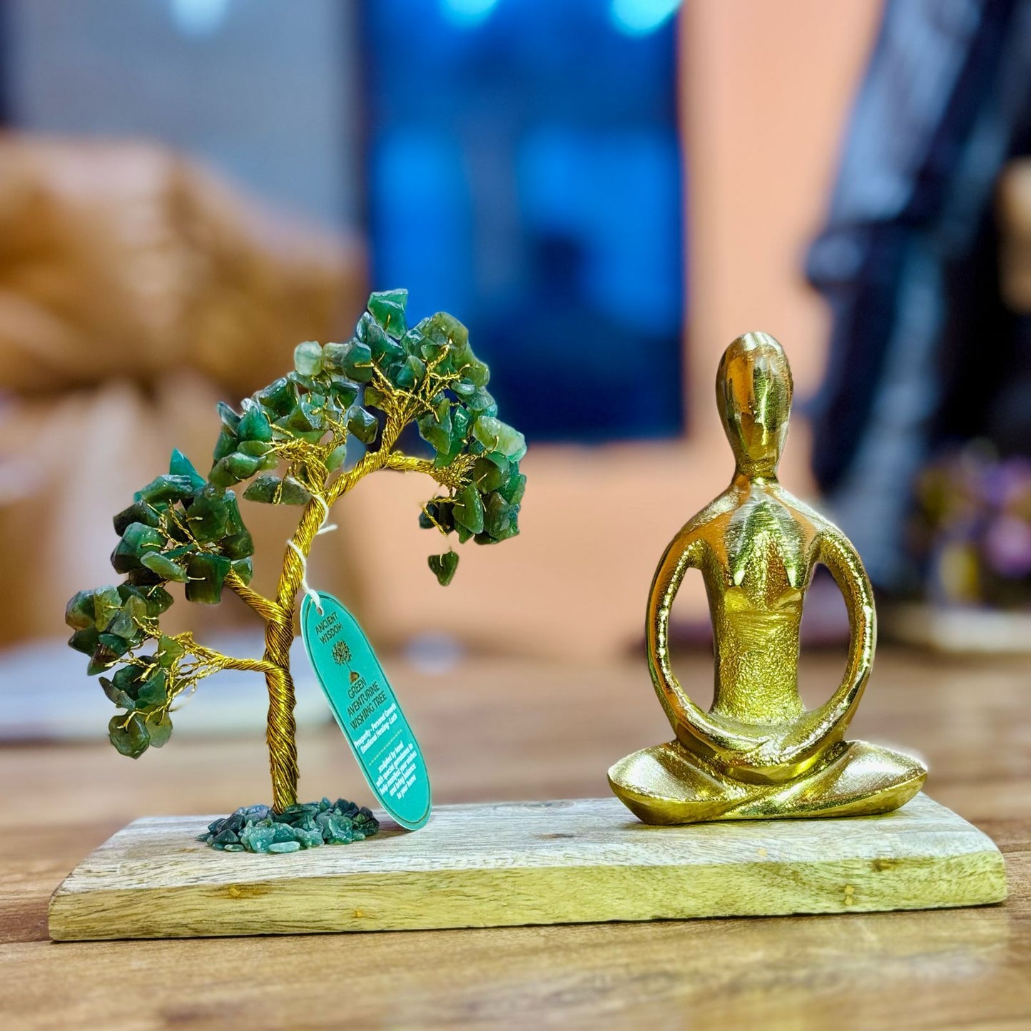 Handcrafted Green Aventurine gemstone tree with 100 chipstones and a figure in a Padmasana yoga pose on a natural stone base.