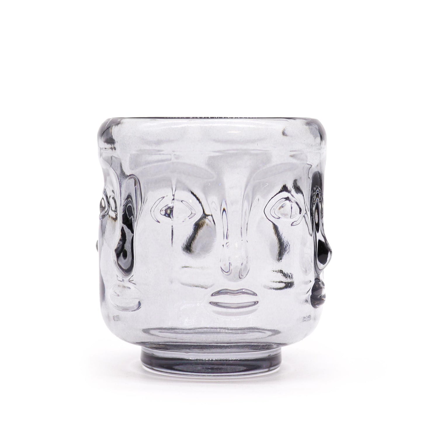 Elegant midnight grey glass candle jar featuring embossed Buddha faces in a circular pattern.