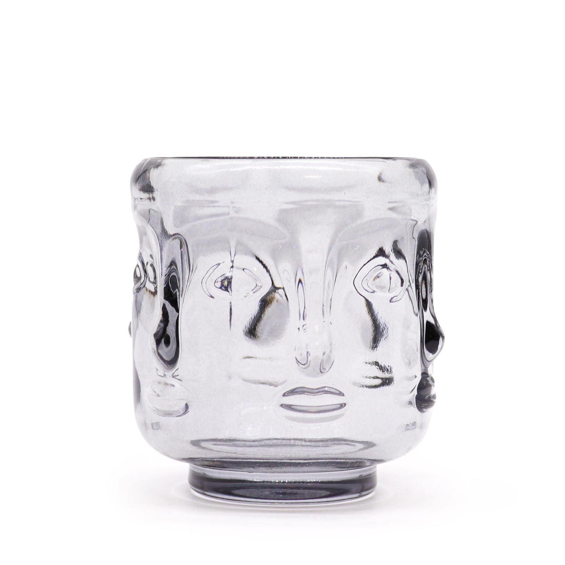 Elegant midnight grey glass candle jar featuring embossed Buddha faces in a circular pattern.