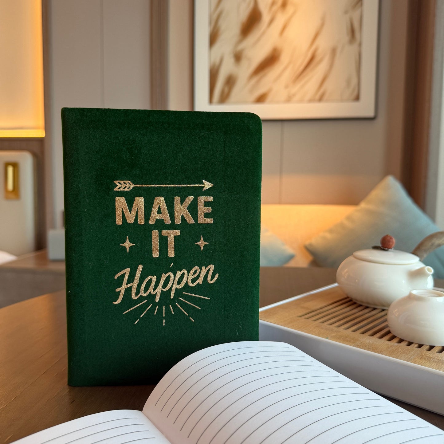 Luxurious dark green velvet notebook with silver embossed text reading Make It Happen on the cover.