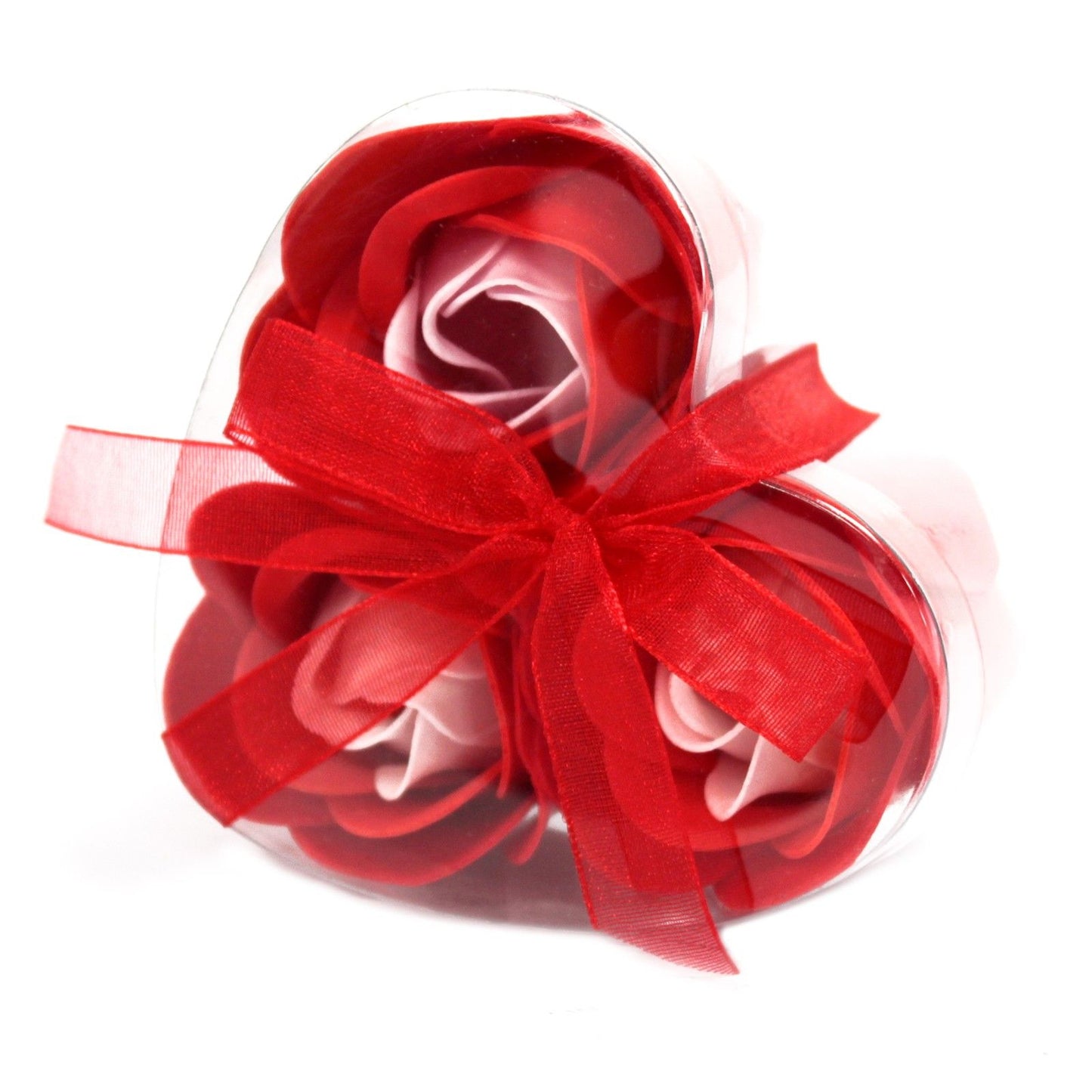 Three delicate red soap roses arranged beautifully inside a heart-shaped gift box for a romantic bath experience.
