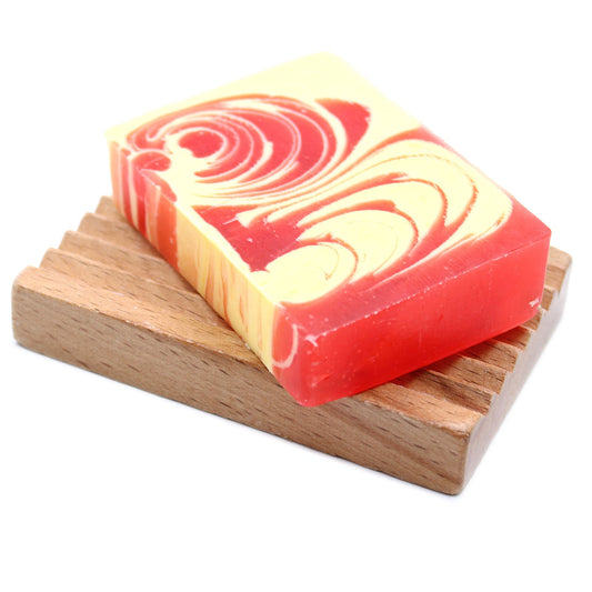 A textured 100g slice of handcrafted strawberry soap with a vibrant pink and white marbled design.