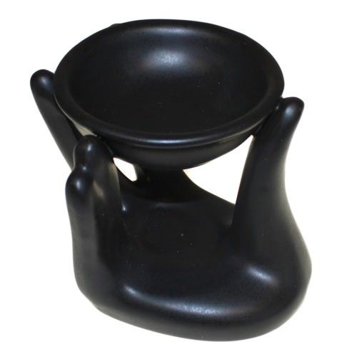 Matte black ceramic oil burner shaped like a cupped hand holding a small bowl for essential oils or wax melts.