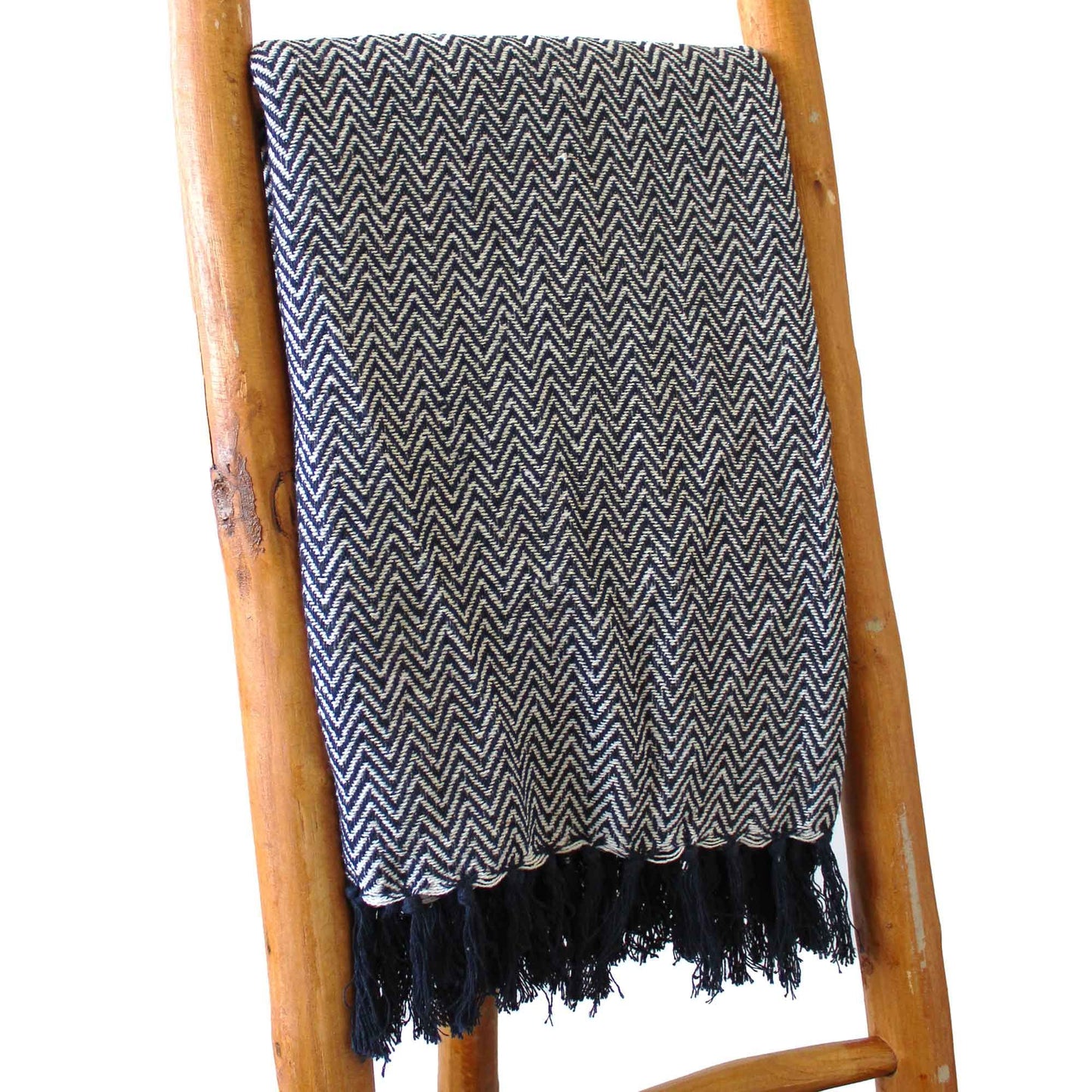 Navy blue and white zigzag patterned cotton throw blanket with decorative fringed tassel edges.