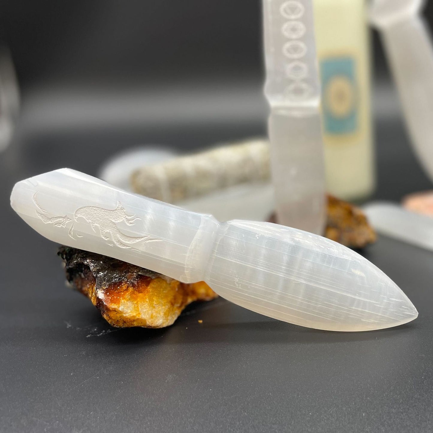 Elegant hand-carved white selenite ritual knife with a pointed blade and natural crystalline texture.