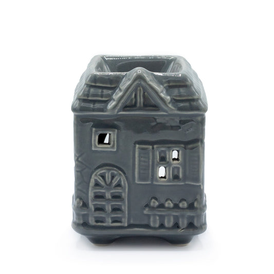 Charming grey ceramic oil burner shaped like a townhouse with windows for light to shine through.