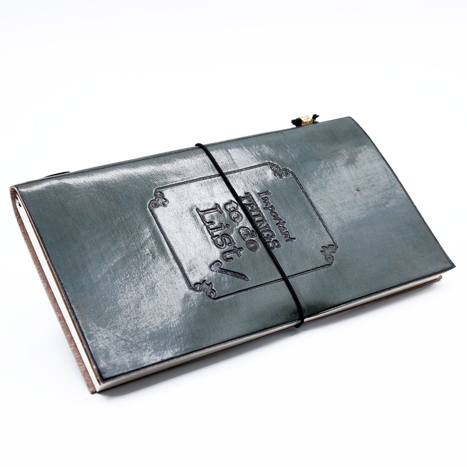 Slim grey handmade leather journal with an embossed quote and a stylish wrap-around leather tie closure.