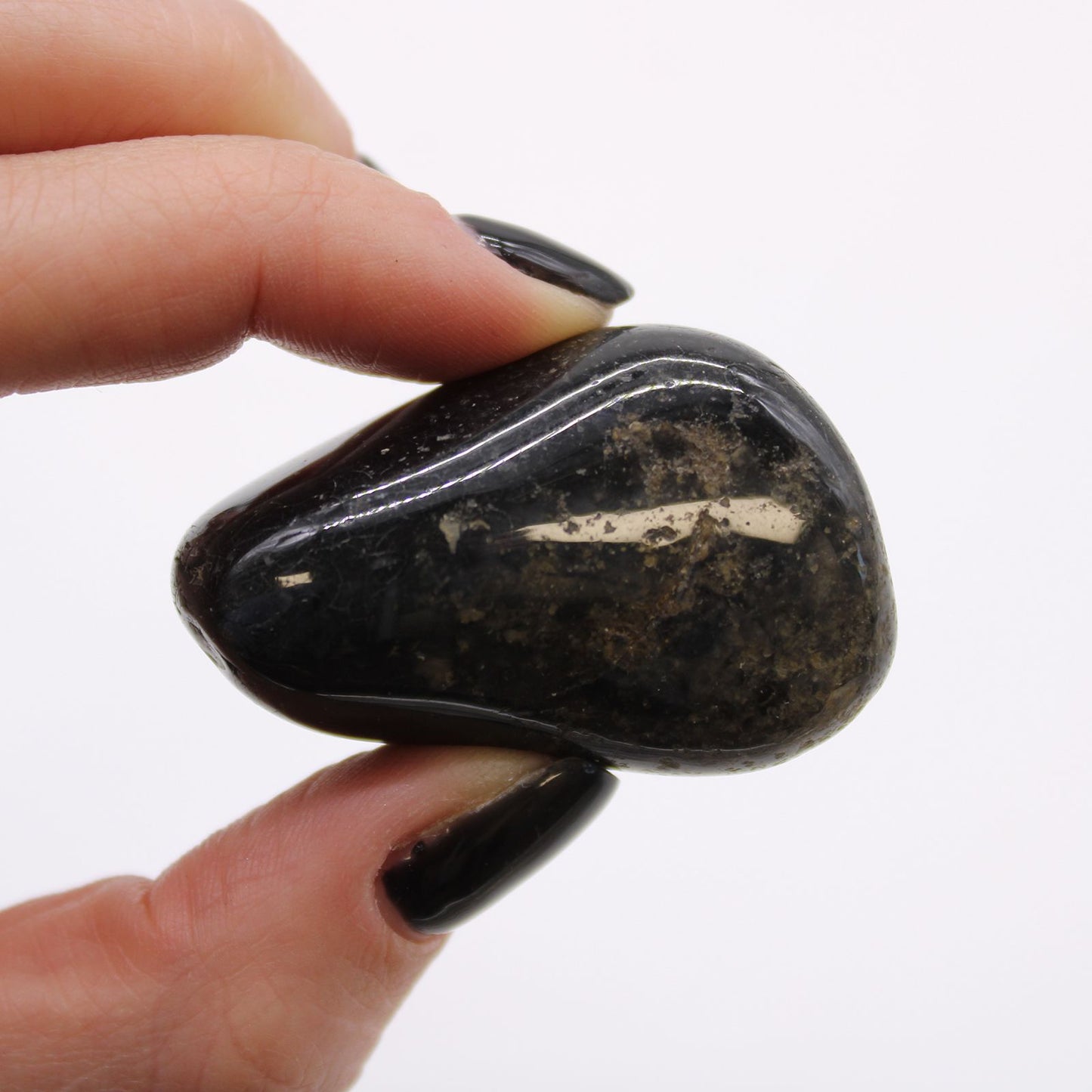 Several large, smooth, and polished black onyx tumble stones with a deep glossy finish.