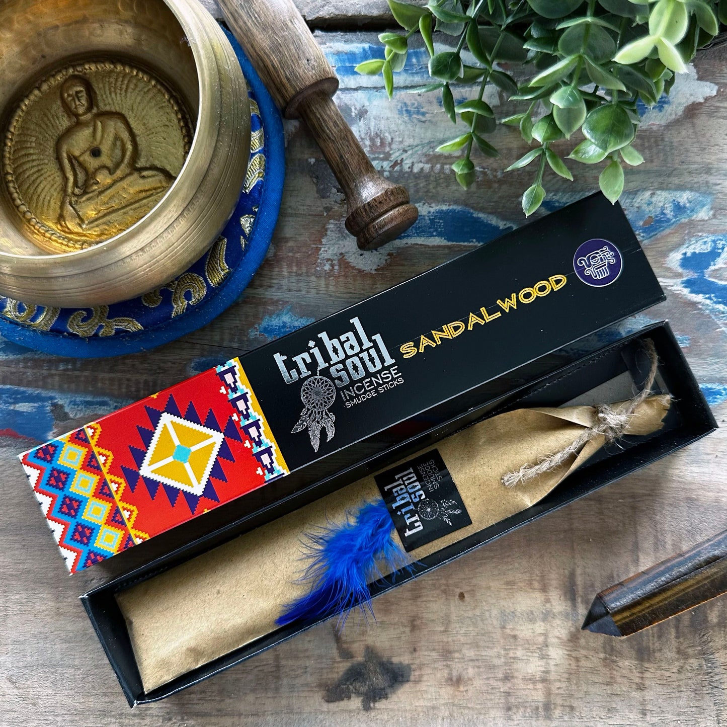 A decorative box of premium sandalwood incense sticks with a traditional design and natural earthy tones.