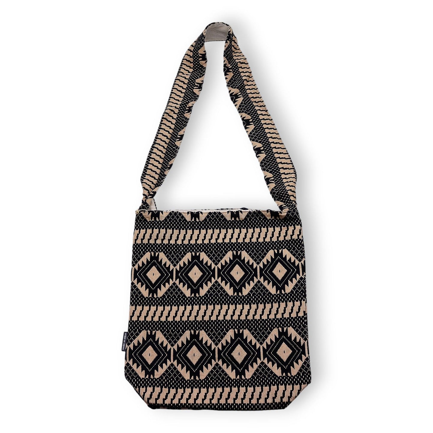 Large woven jacquard carryall bag featuring a bold geometric pattern in warm earthy brown and cream tones.