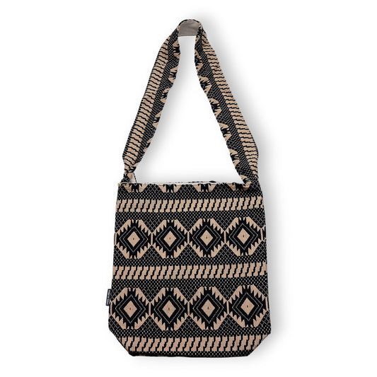 Large woven jacquard carryall bag featuring a bold geometric pattern in warm earthy brown and cream tones.