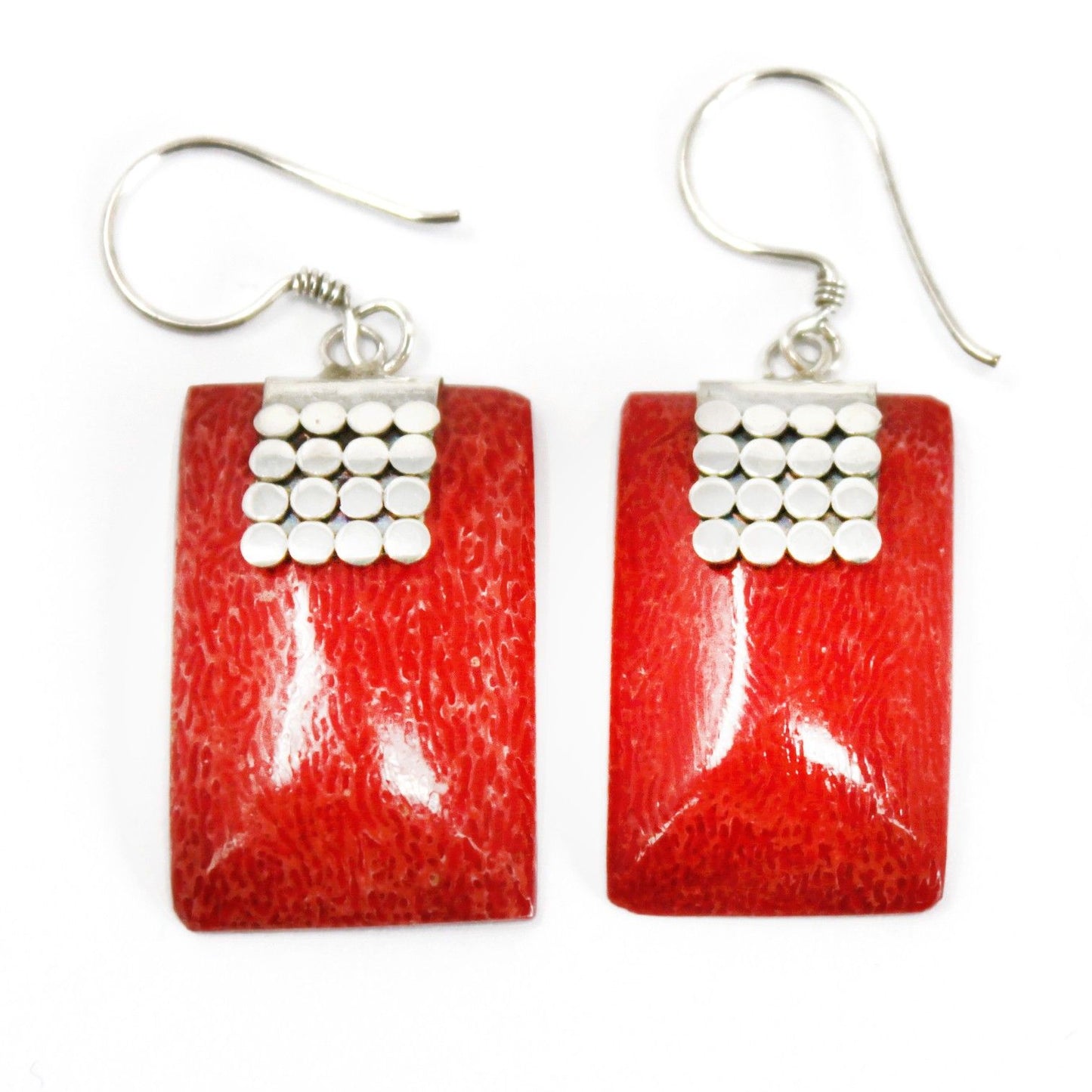Hand-made 925 silver earrings featuring small square discs with a smooth, bright red coral effect resin inlay.