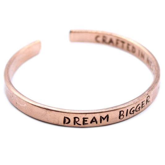 Handcrafted copper and brass bangles with engraved inspirational messages and a rustic hammered finish.