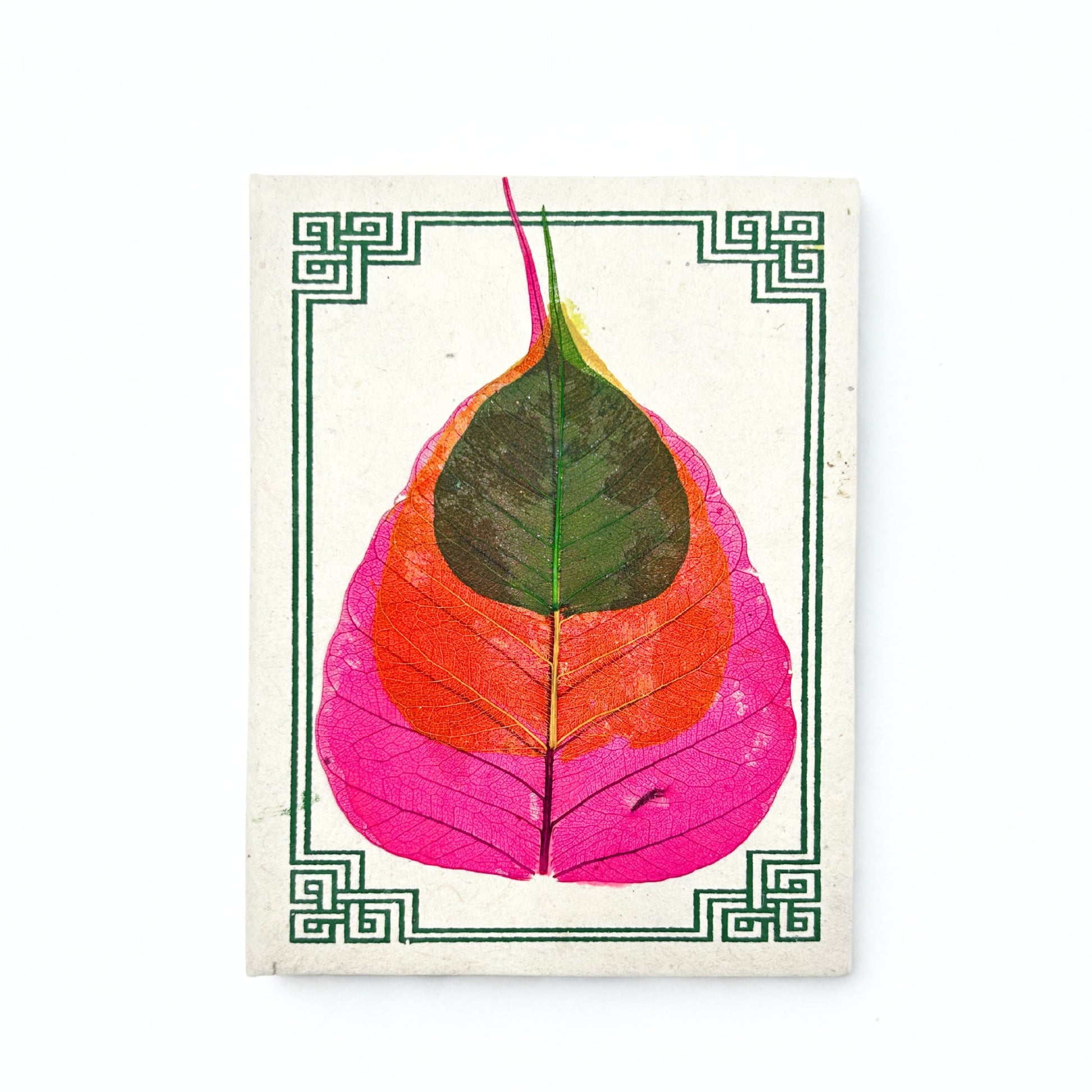 Handmade Lokta paper notebook with a real pressed Bodhi leaf on the cover and a simple patterned border.