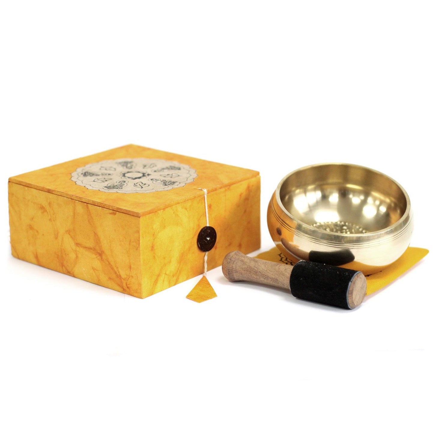 Handcrafted meditation singing bowl set featuring a brass bowl, traditional patterned cushion, and wooden striker.