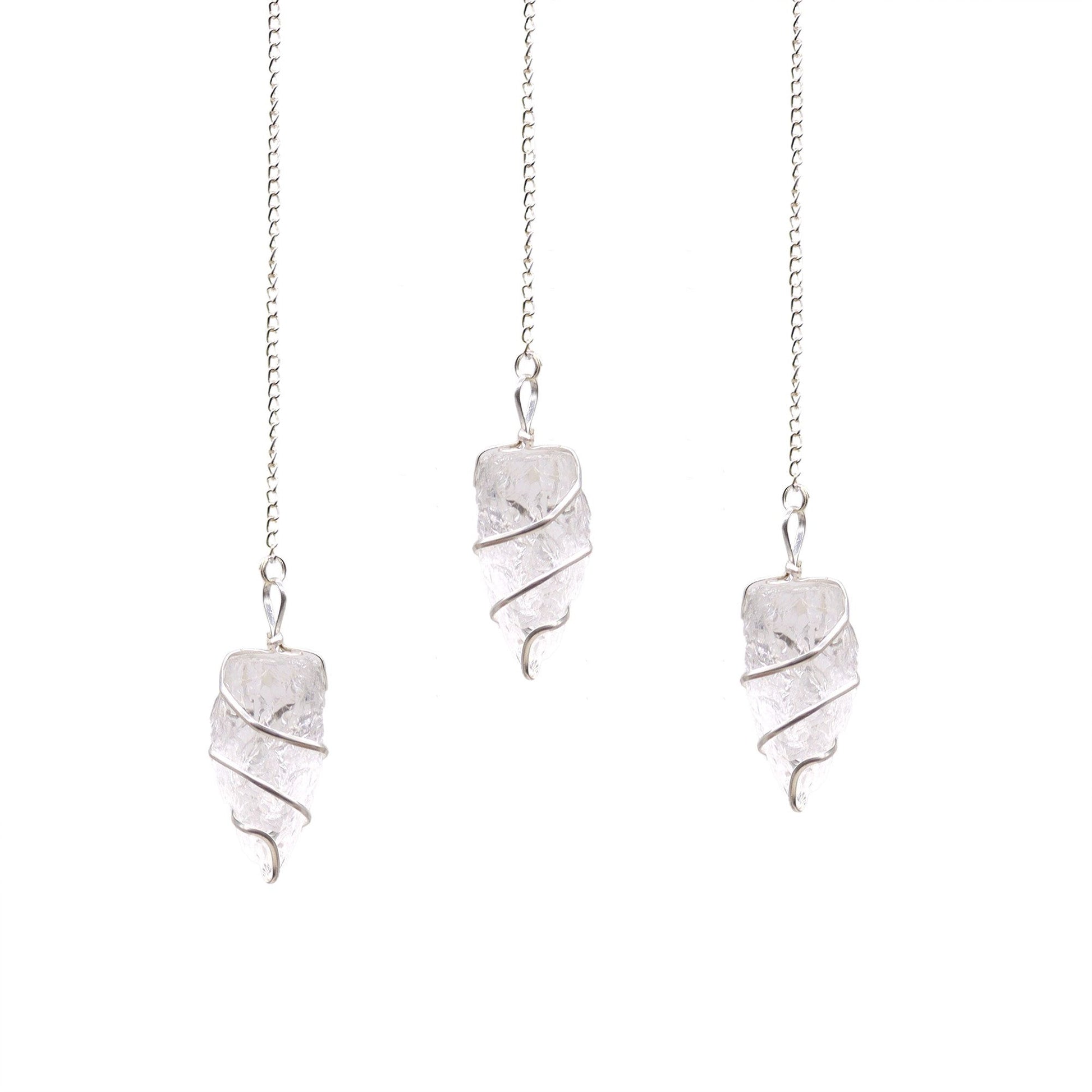 A natural, unpolished clear rock quartz gemstone pendulum suspended from a simple silver-coloured chain.