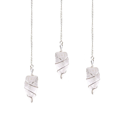 A natural, unpolished clear rock quartz gemstone pendulum suspended from a simple silver-coloured chain.