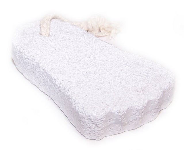 Natural volcanic pumice stone shaped like a foot with a hanging rope for exfoliation and skin care.