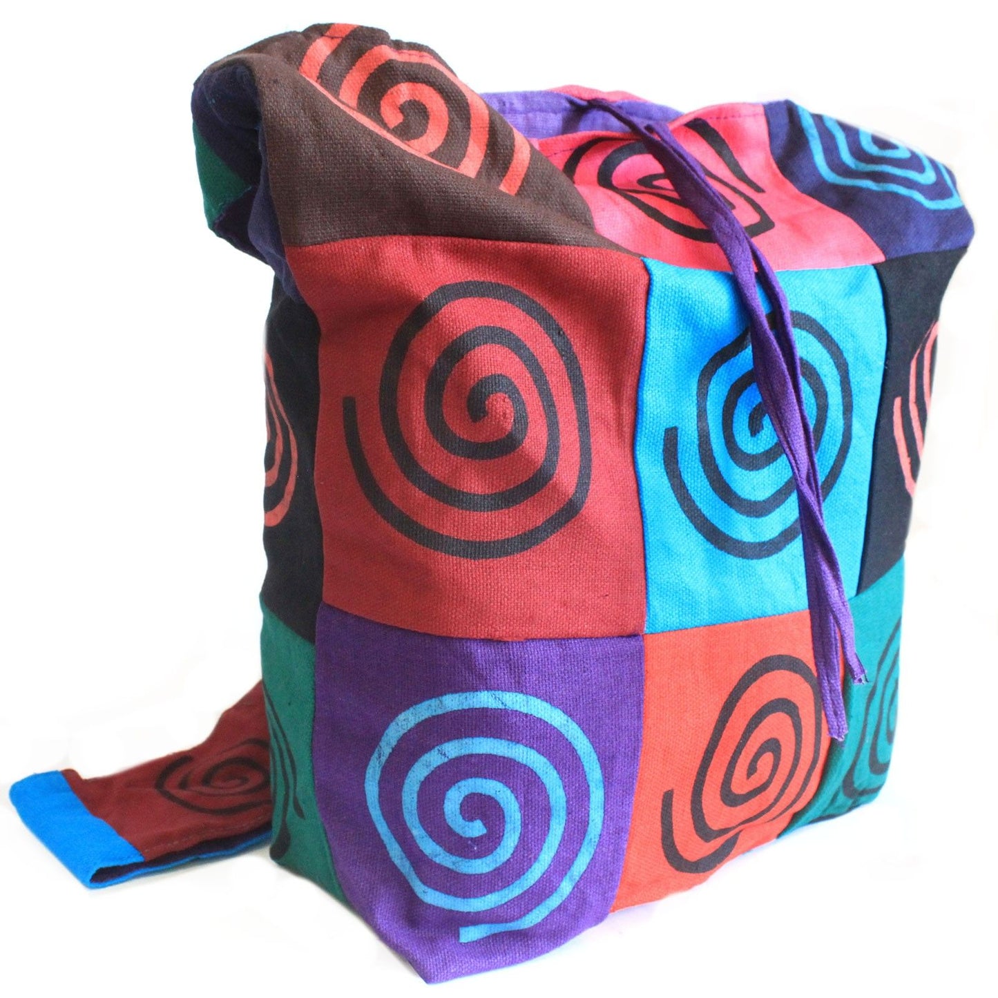 Vibrant cotton patch sling bag featuring a colourful spiral design and a wide comfortable shoulder strap.