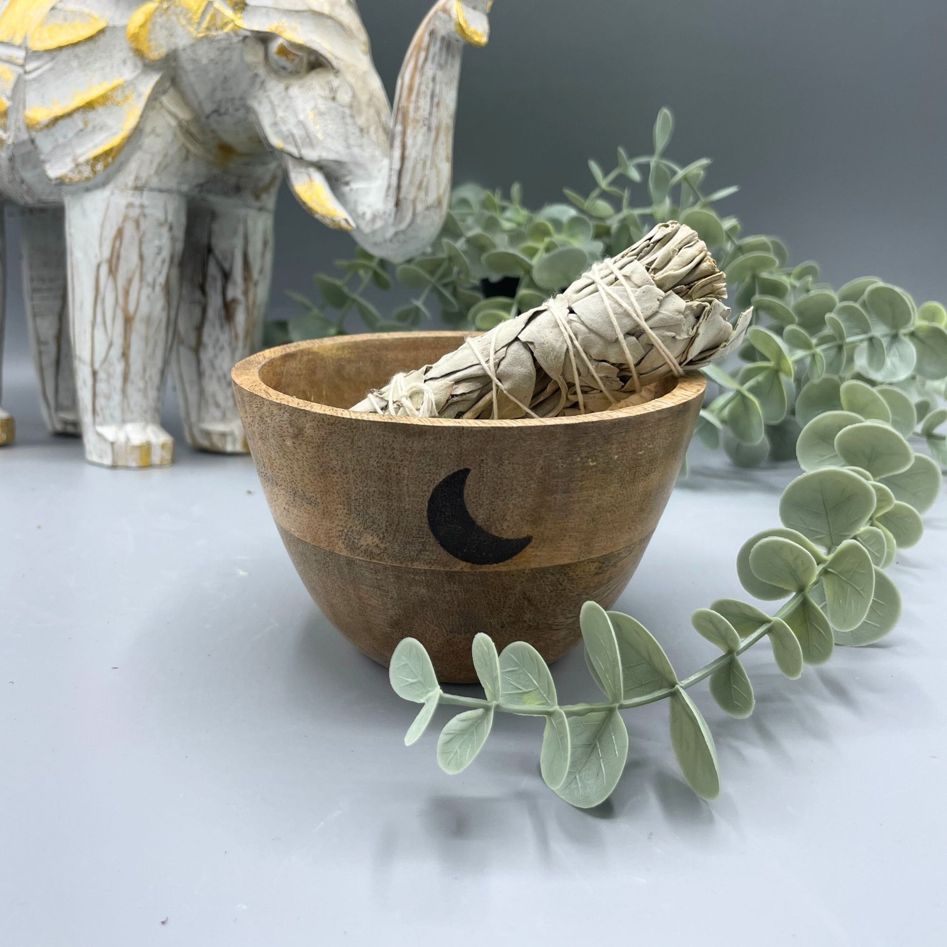 Hand-carved wooden ritual bowl featuring a Triple Moon symbol on a natural grain finish.