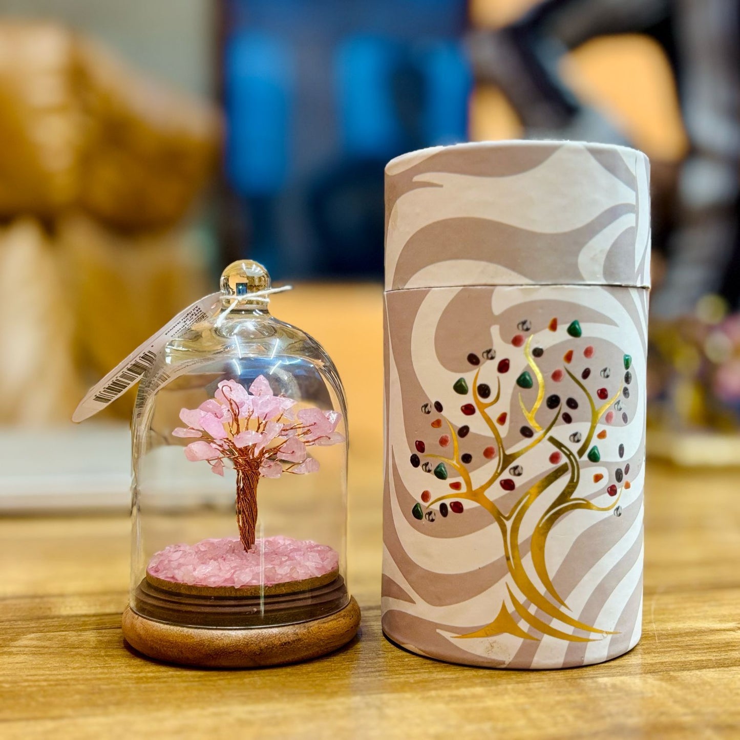 Handcrafted Rose Quartz gemstone tree with thirty chipstones elegantly encased in a clear glass display dome.