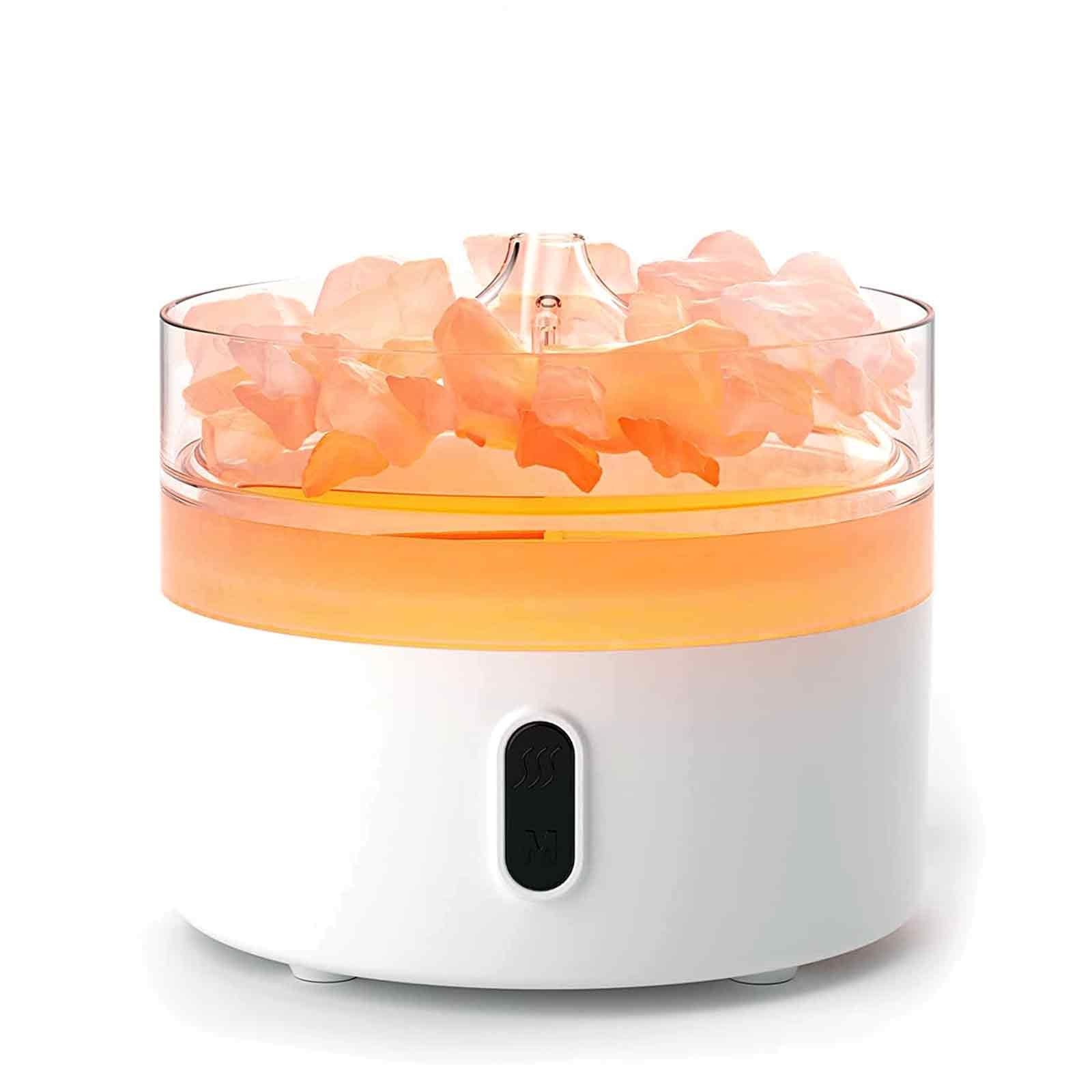 Elegant black aroma diffuser with glowing orange flame effect and natural Himalayan salt chunks in the base.