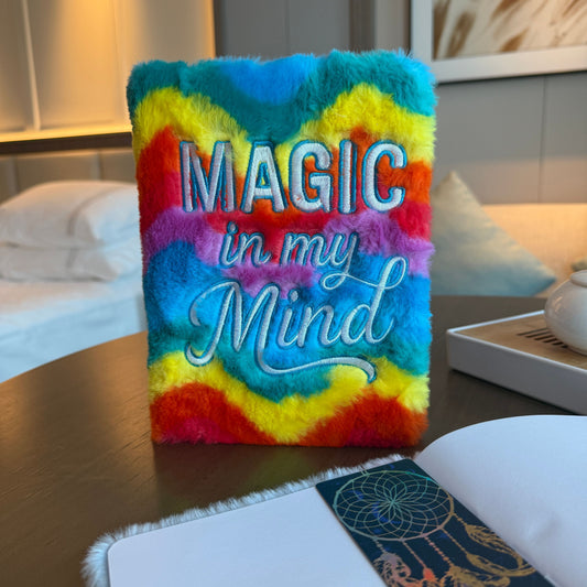 Vibrant rainbow faux-fur soft journal with 'Magic in my Mind' embroidered on the cover.