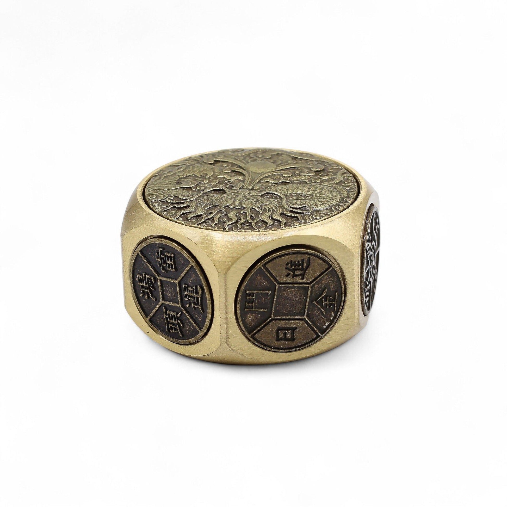 Detailed bronze-coloured metal spinner engraved with a powerful traditional dragon design.