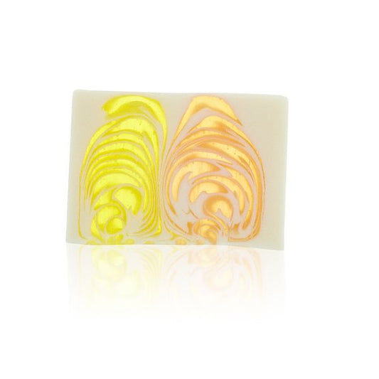 Textured orange and cream handcrafted soap slice with a rustic finish and natural botanical appearance.