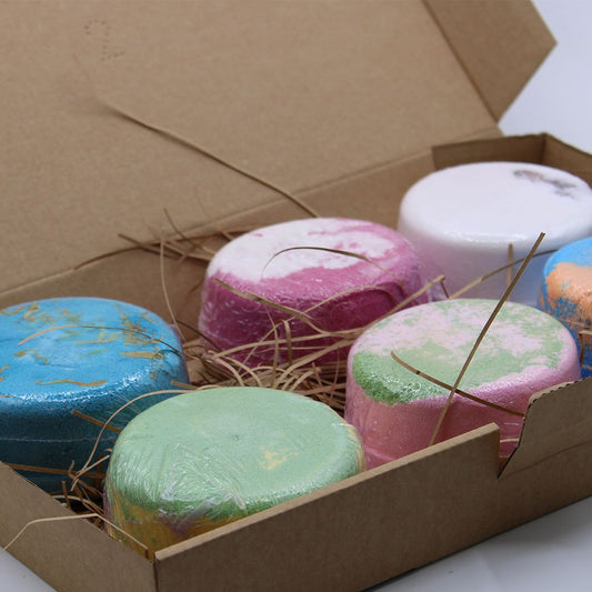 Six large artisanal floral bath fizzes with botanical decorations in a rustic gift box.