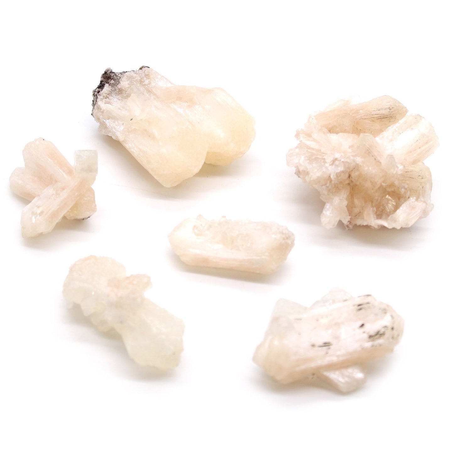 Small cluster of white stilbite crystals combined with clear apophyllite on a natural mineral matrix.