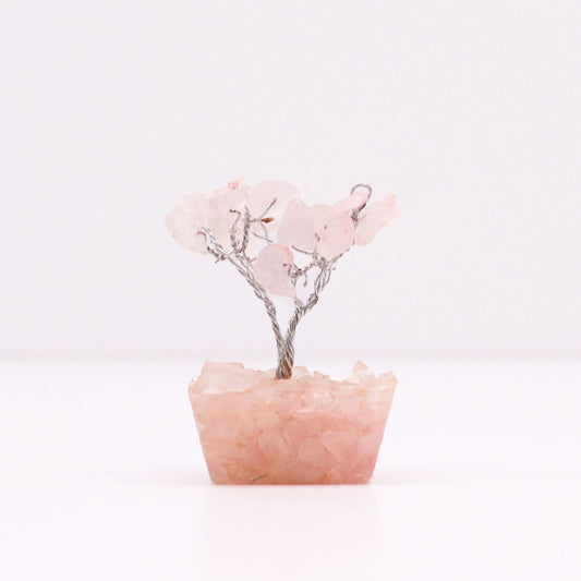 Delicate mini rose quartz gemstone tree with fifteen stones set on a decorative orgonite base.