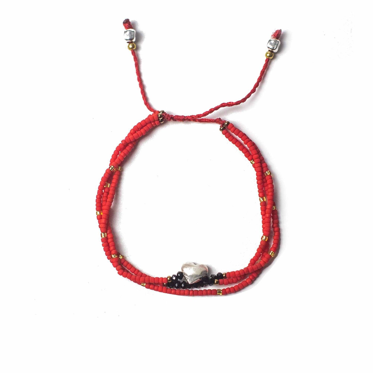 Handcrafted red string bracelet featuring delicate beads and a small silver heart charm.