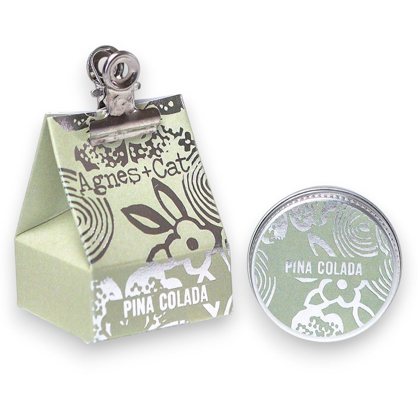 Small round tin of tropical Piña Colada scented lip balm with a smooth, creamy texture.