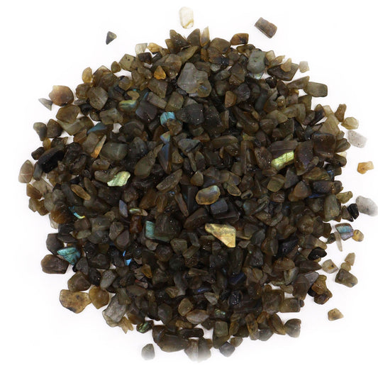 Pile of small, polished labradorite gemstone chips showing natural grey tones with shimmering blue and green flashes.