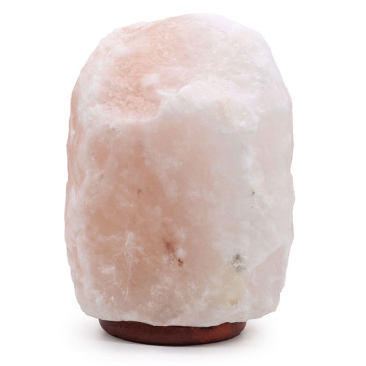 Extra large natural Himalayan salt lamp on a wooden base emitting a warm orange glow.