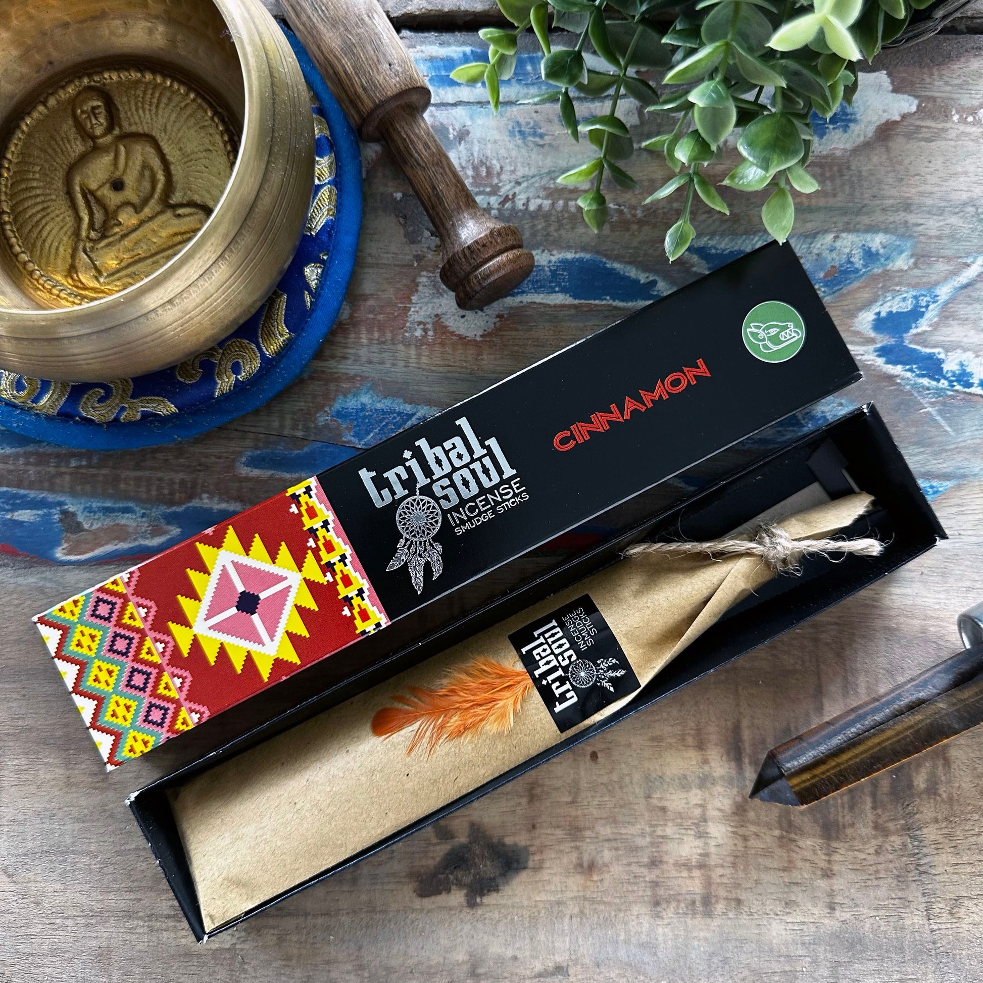 Hand-rolled incense sticks with a natural finish, releasing a thin trail of smoke against a neutral background.