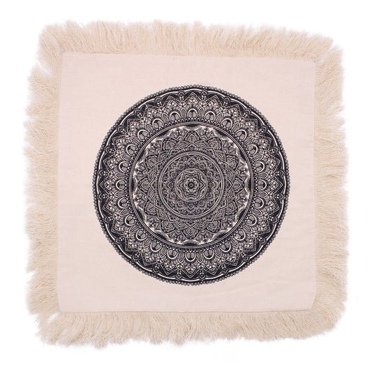 Square black cushion cover featuring a detailed white traditional mandala pattern.