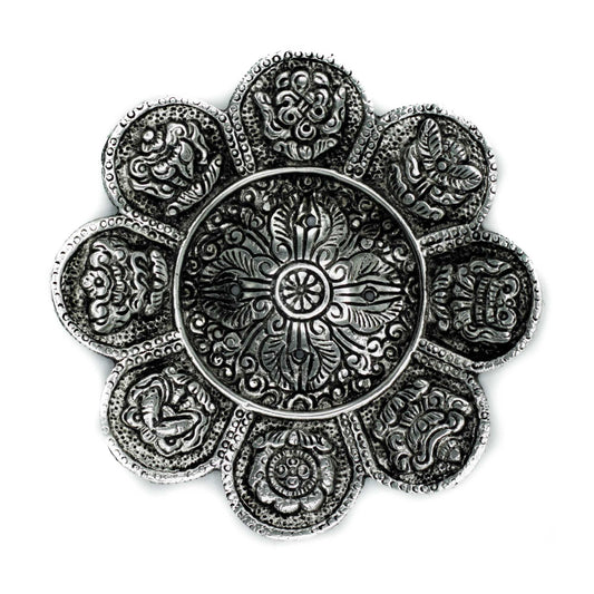 Handcrafted polished aluminium incense holder with engraved Tibetan symbols and a tall cylindrical design.