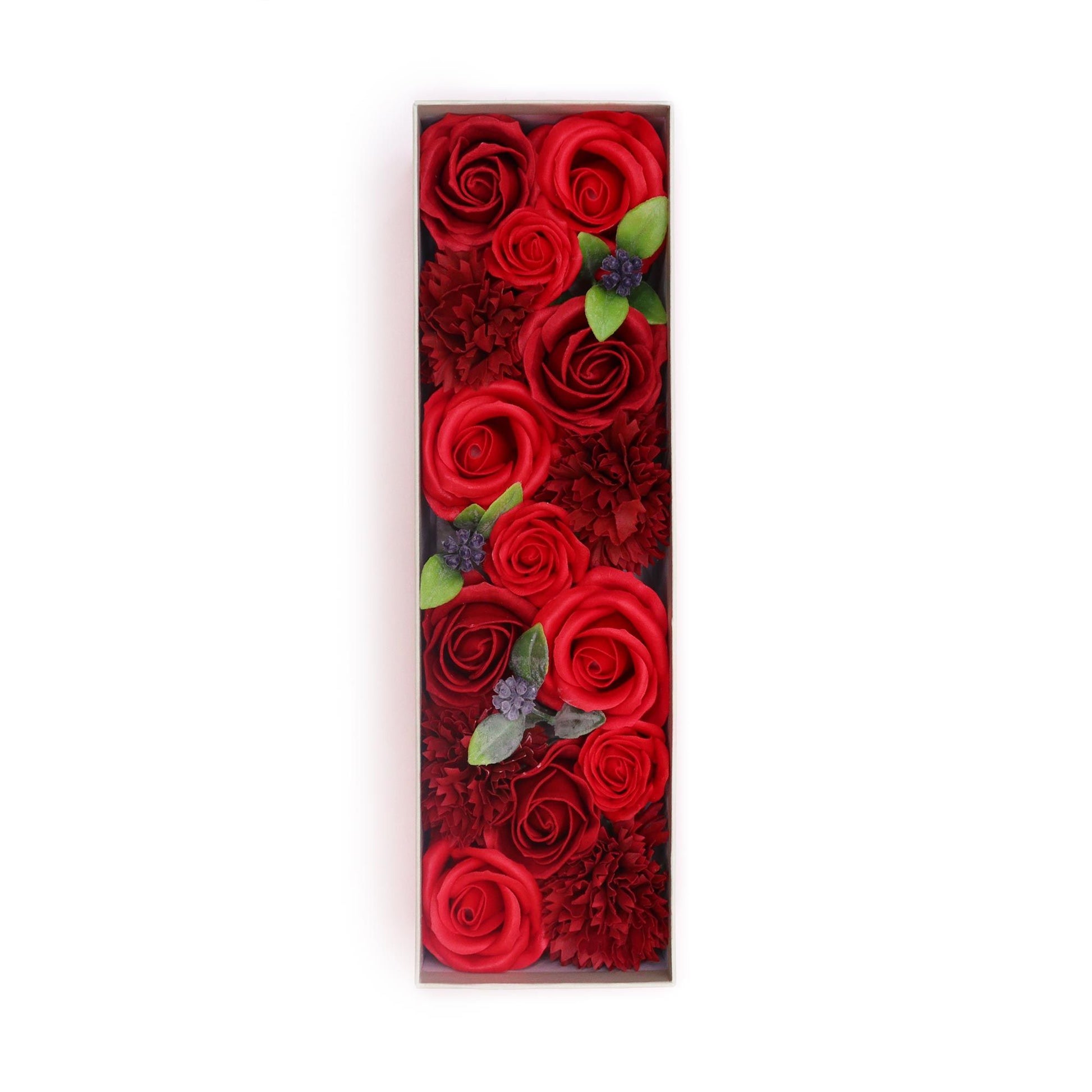 Elegant long gift box filled with realistic red soap rose petals and delicate greenery.