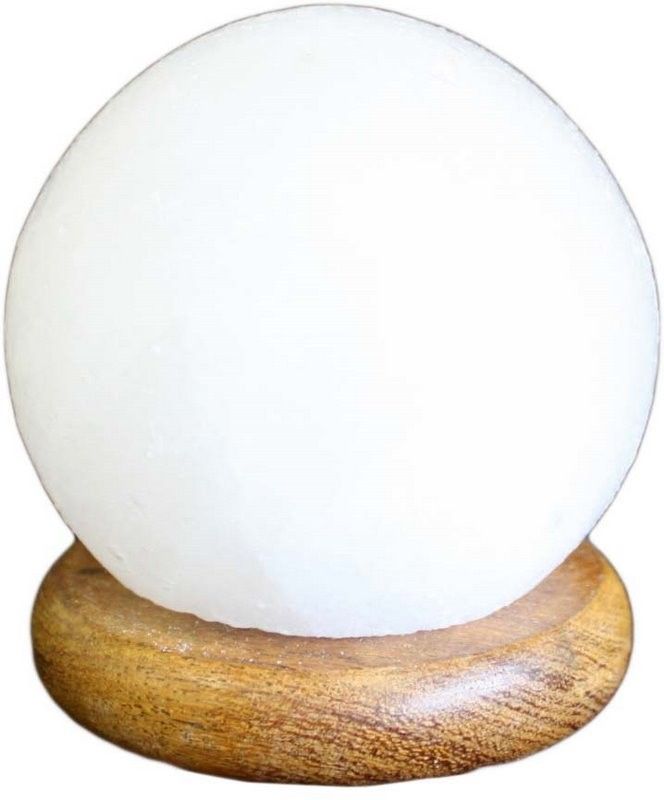 Small spherical pink Himalayan salt lamp on a dark wooden base, glowing with a soft warm orange light.