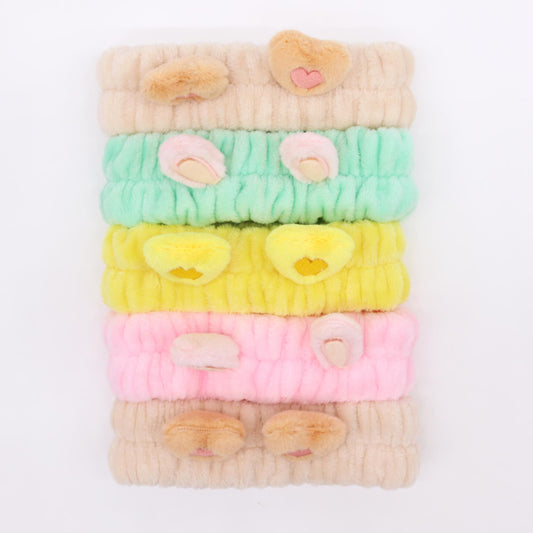 Selection of five soft flannel makeup headbands featuring cute plush heart and animal ear designs in assorted colours.