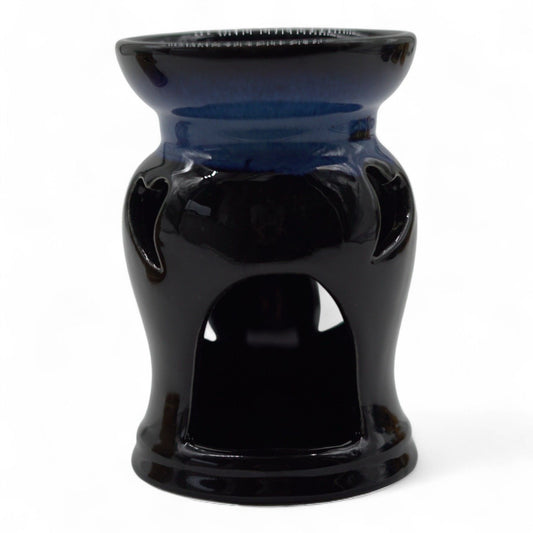 Rustic terracotta-style ceramic oil burner featuring a decorative heart cut-out design on a tactile surface.