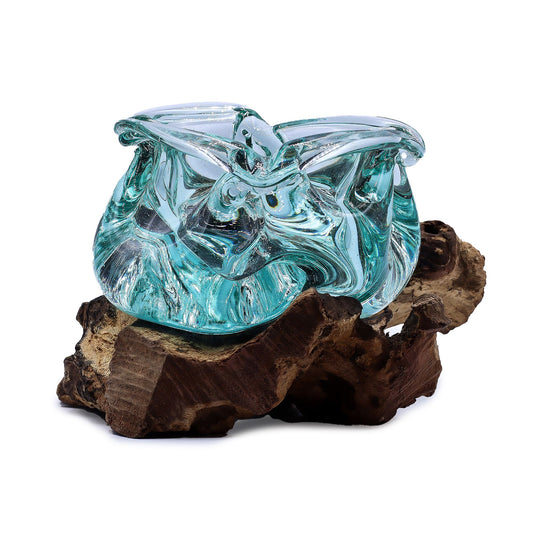 Hand-blown molten glass bowl shaped as an ashtray or candle holder resting on a natural gnarled wood base.
