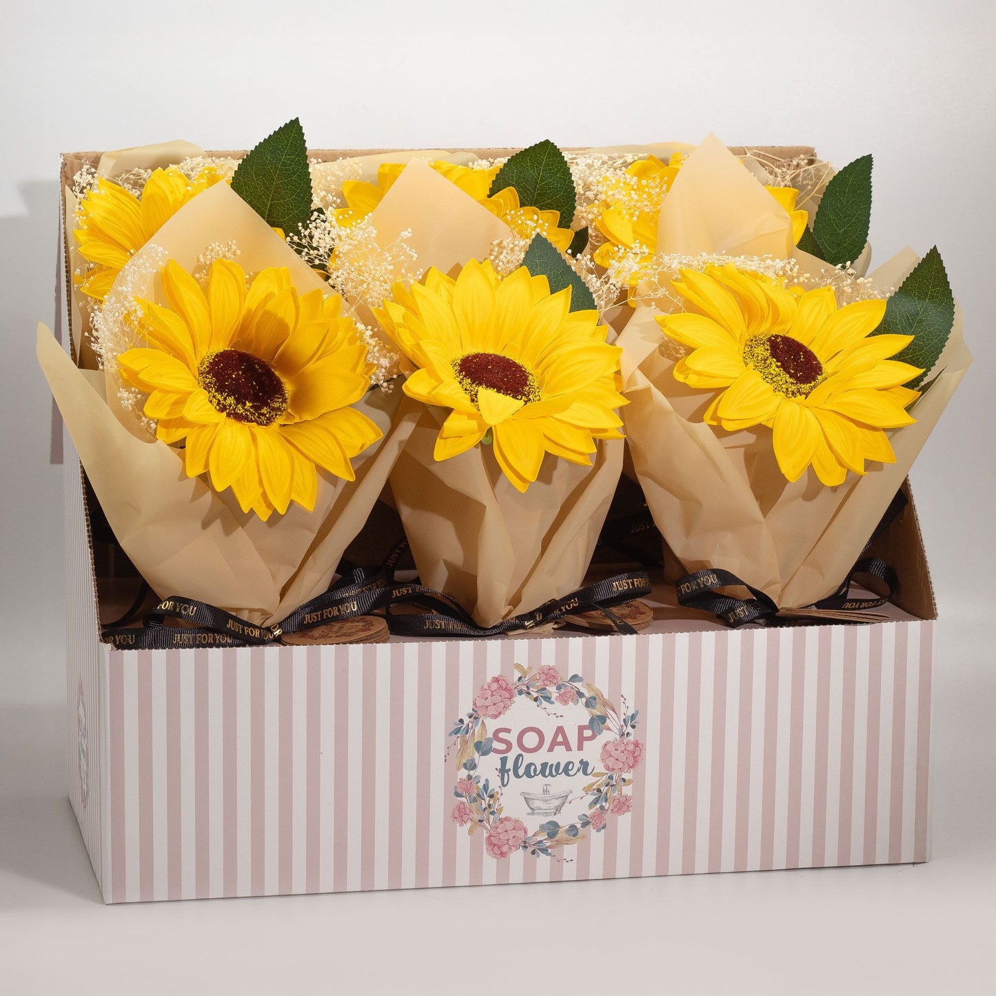 Artisanal yellow soap flower sunflower with realistic petals, wrapped elegantly with a decorative ribbon.