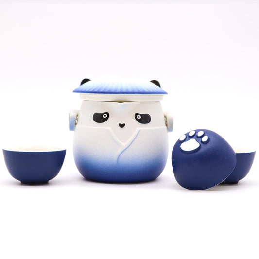 Ceramic sky blue teapot and three matching cups featuring a cute panda design and bamboo accents.